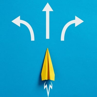 yellow paper plan on blue background heads toward three white direction arrows.